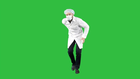 Doctor wearing his uniform and wearing a mask he is walking