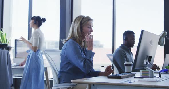 Woman with headset working on computer