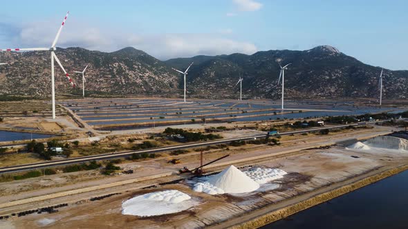 Aerial view of salt fields spread across windmill farm in Phan Rang. Vietnam.