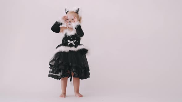 Toddler Girl in Black Cat Costume on White Background