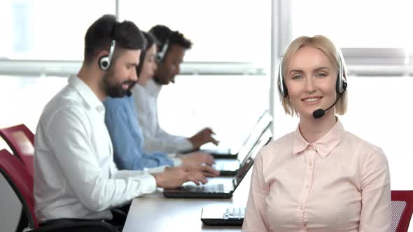 Blond Woman with Headset Smiling in Office.