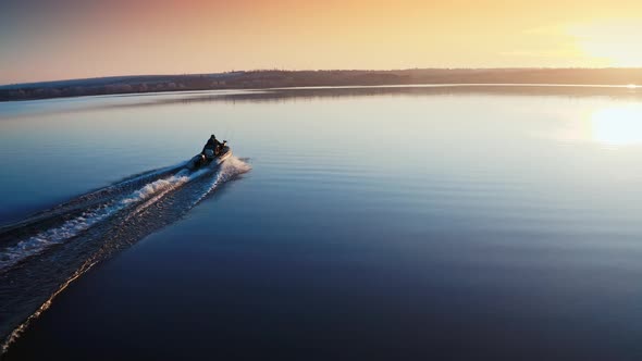 Boat on Water Surface at Sunset