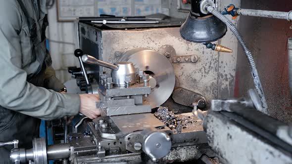 The Turner Grinds the Part on the Lathe