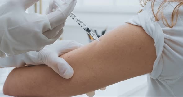 Close Up Shot of Doctor Injecting Vaccine To Female Hand, Flu and Coronavirus Prevention