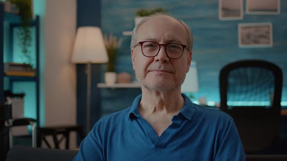 Portrait of Senior Adult Looking at Camera in Living Room