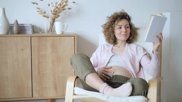 Pregnancy, People, Leisure And Happy Lifestyle Concept. Pregnant Woman Reading At Home.