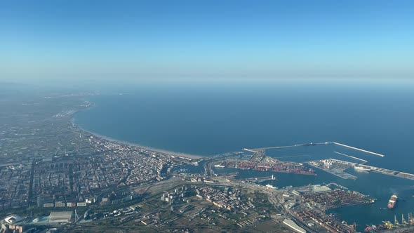 Aerial view from a jet cockpit of Valencia harbor and northern coast al 3000m high, pilot POV, in a