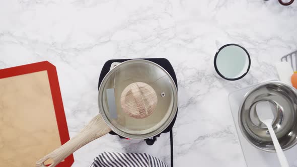 Flat lay. Step by step. Caramelizing sugar in a small cooking pot over the small electric stove