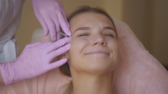 Closeup Portrait of Female Face with Closed Eyes Getting Biorevitalization of the Face Procedure