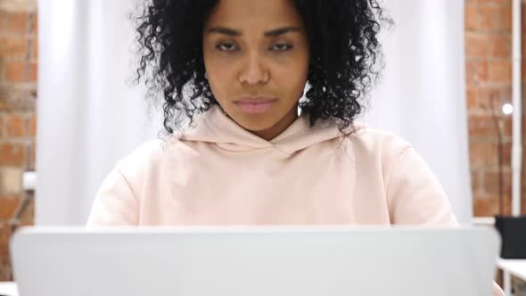 Smiling Positive AfroAmerican Woman Working on Laptop