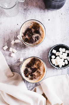 Trendy fluffy coke with marshmallow in  glasses on the table top and vertical view