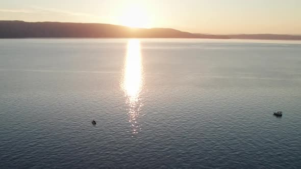 Aerial View of Landscape Sunset Over the Sea Leaves Trail and Glare on the Water