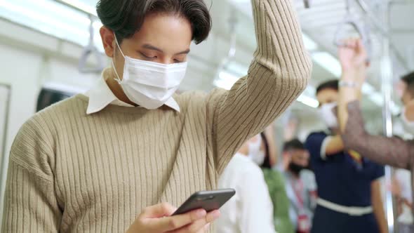 Traveler Wearing Face Mask While Using Mobile Phone on Public Train