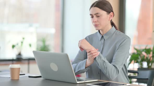 Young Latin Woman Having Wrist Pain While Typing on Laptop