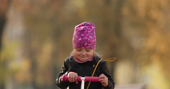 Pretty Little Girl in Black Jacket Smiles and Rejoices