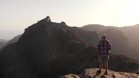 Man Hiker Standing on the Edge of a Cliff in the Mountains of Madeira Island, Portugal