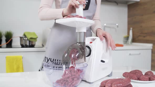 Making Raw Mincemeat with Meat Mincer at Home. Pile of Chopped Meat. Electric Mincer Machine with