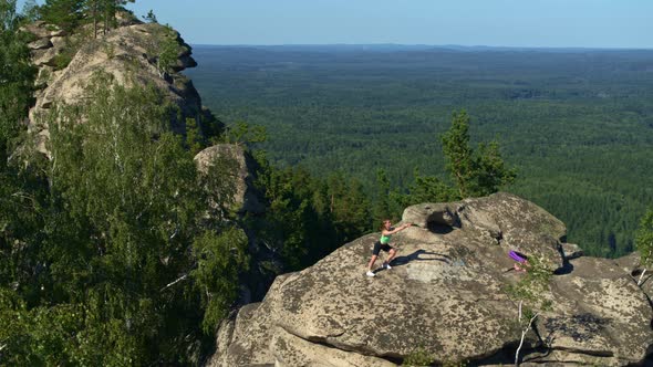 the Girl Does Yoga and Fitness in Nature