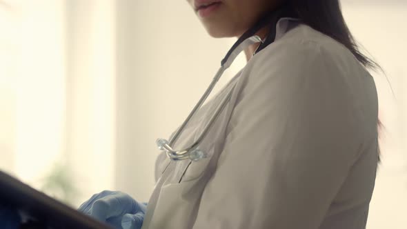 Doctor Woman Using Tablet Computer in Clinic Close Up