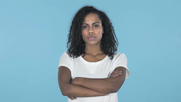 African Girl Looking at Camera Isolated on Blue Background