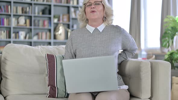 Exhausted Old Woman Working on Laptop and Having Back Pain