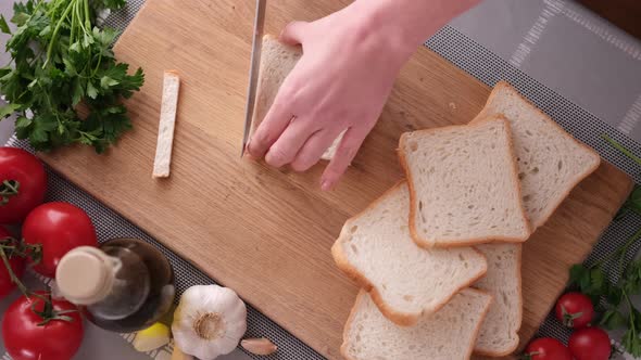 Making Caesar Salad Croutons By Slicing Toast Bread