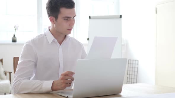 Excited Businessman Celebrating Results While Reading Documents Letter