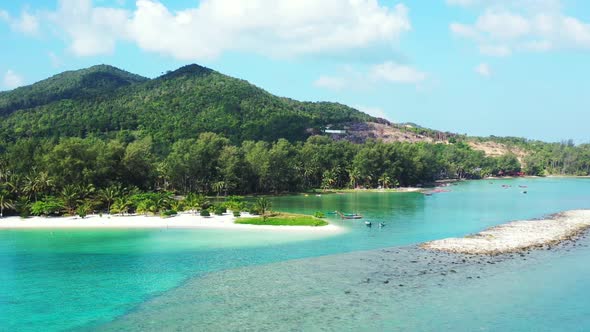 Aerial seascape of paradise tourist beach adventure by blue water and white sandy background of a da