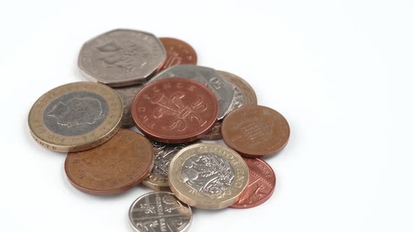 UK Currency pounds coins rotating close up footage against the white background