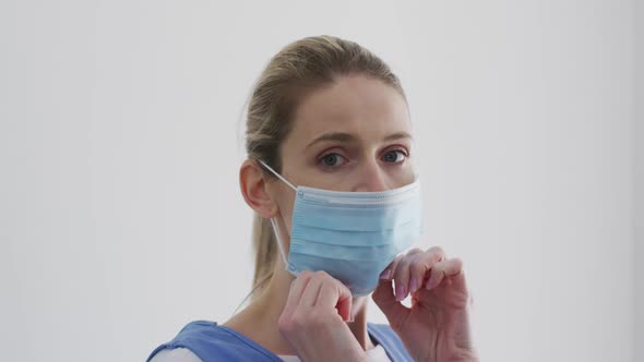 Female health worker wearing face mask at home