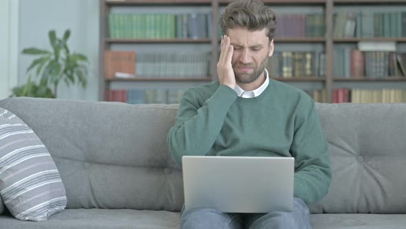 Tired Man Having Headache While Working on His Laptop