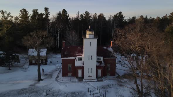 4k drone video of 40 Mile Point Lighthouse in Presque Isle County in Michigan during the winter.