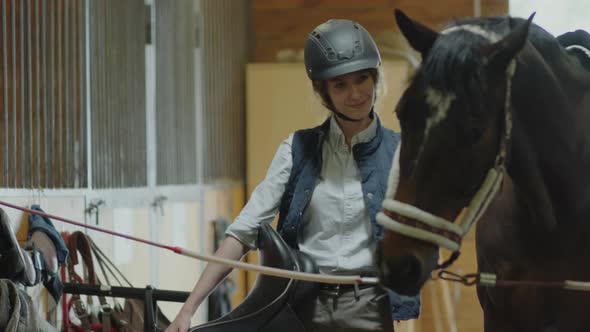 Female Stable Worker Petting Horse