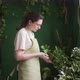 Female Florist Takes Care of House Plants - VideoHive Item for Sale
