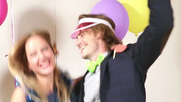 Cute happy couple dancing in photo booth