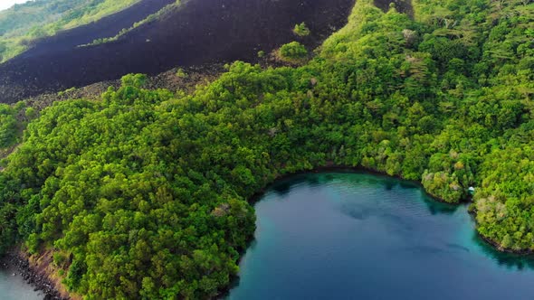 Aerial: flying over Banda Islands active volcano Gunung Api lava flows Indonesia