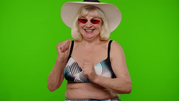 Senior Pensioner Woman Tourist in Swimsuit Bra Red Sunglasses and Hat Dancing Celebrating Smiling