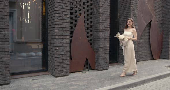 Young Beautiful Girl Holding a Bouquet of Flowers