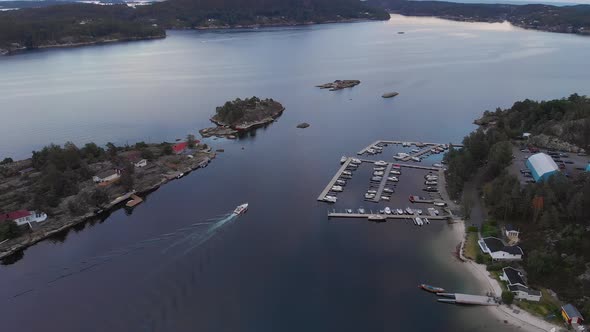 Idyllic location with beach, dock and summer cabins in Kragerofjorden; golden hour