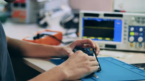 Cellphone Is Getting Repaired By a Serviceman