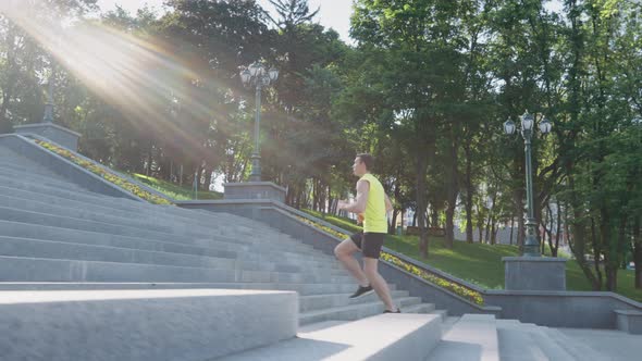 Slow Motion Sporty Man Running Upstairs in Park