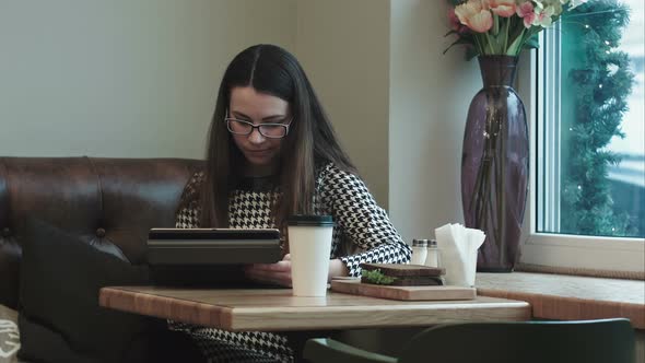 Business Woman on Lunch Break with Tablet in Cafe or Restaurant Working
