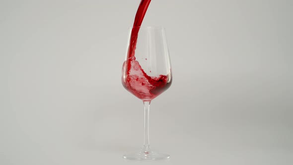 Pouring Red Wine in Glass at 1000 Fps Slow Motion Shot with White Background