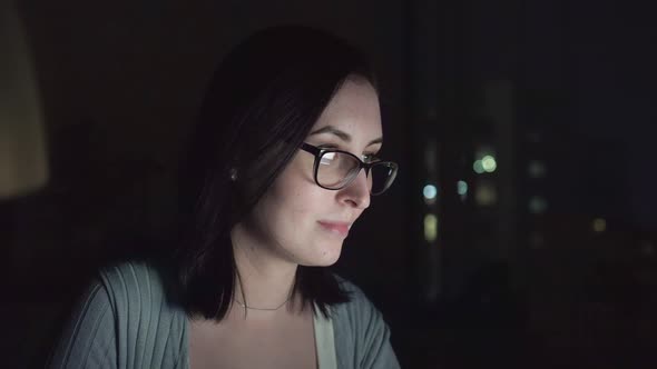 Close Up of a Lonely Young Girl Using a laptop.In the Glasses Reflection of the Monitor