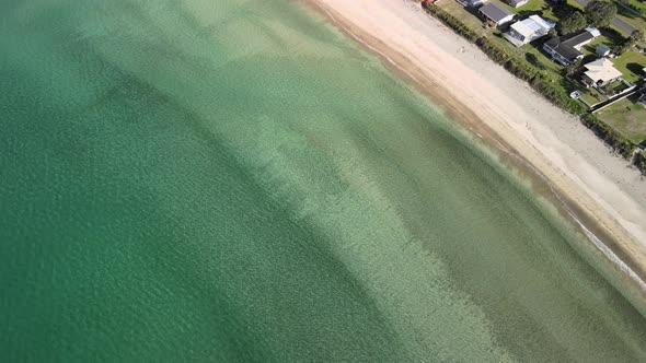 Watching waves roll in from the sky at beach front property in New Zealand's Taupo Bay.