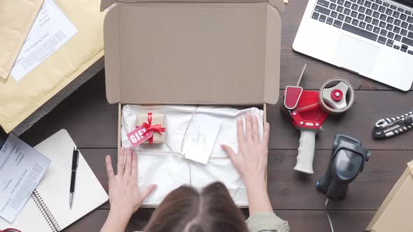Top View of Female Online Store Business Owner Packing Ecommerce Shipping Box