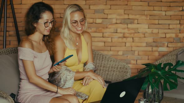 Two Cheerful Women with Laptop