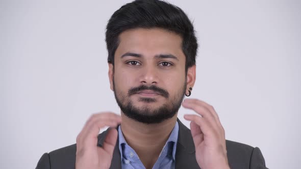 Young Handsome Bearded Indian Businessman Covering Ears As Three Wise Monkeys Concept