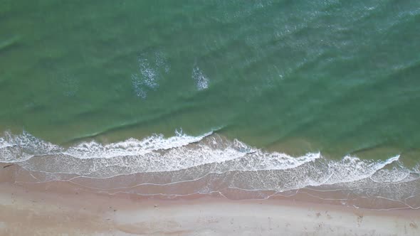 4K Aerial view top view of drone, sea waves and beautiful sand beach.