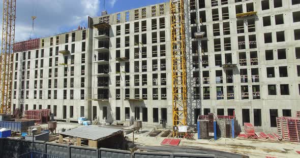 Aerial Shot of Unfinished Residential Compound with Builders Working alt